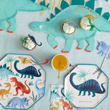 Meri Meri Dinosaur Kingdom Large Napkins on a party table with dinosaur plates and a stegosaurus platter