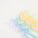 Close-up of Meri Meri Pastel Swirly Candles in lavender, mint, yellow, peach and blue laid in a row
