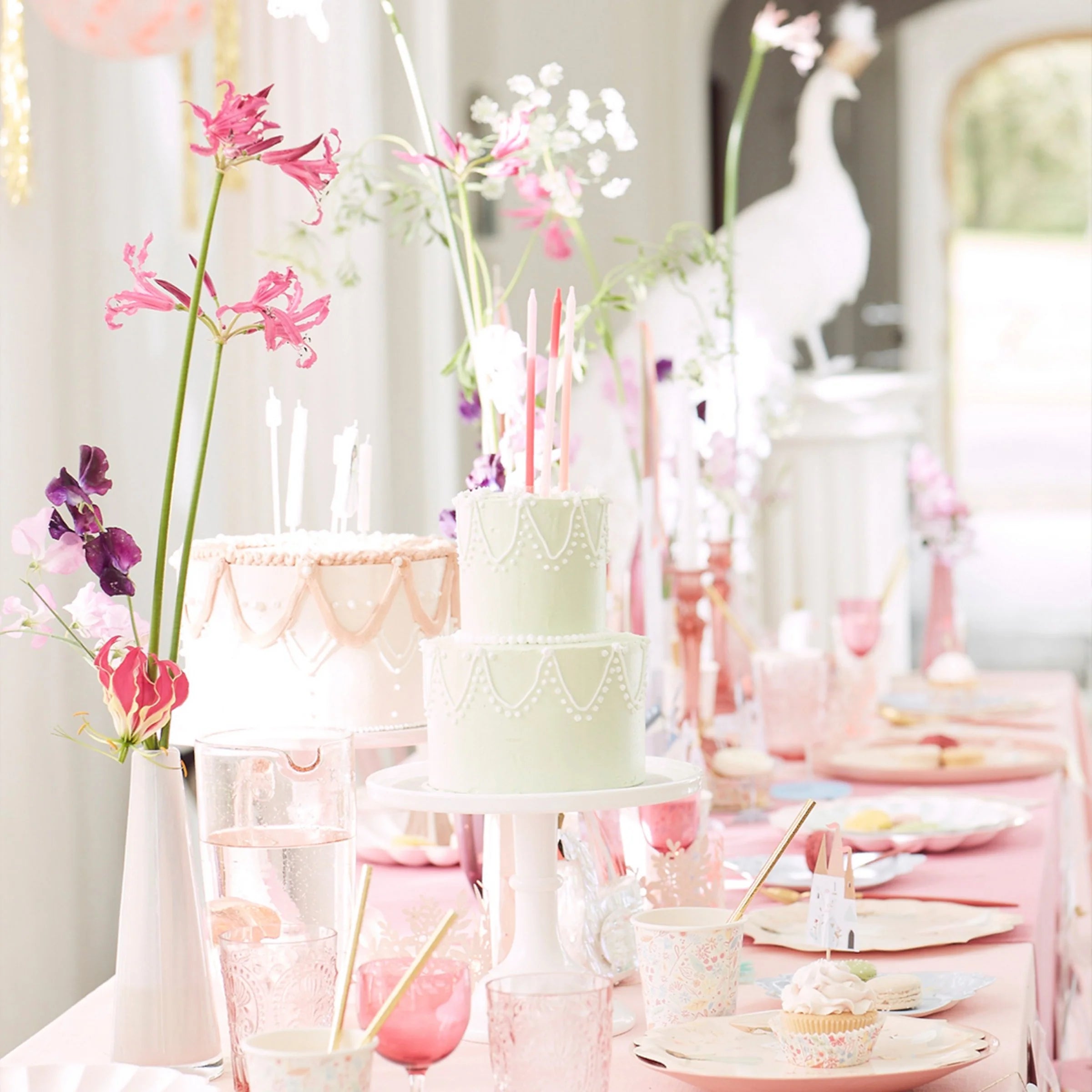 Pink princess party table with cakes and flowers set with Meri Meri Princess Large Napkins