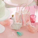 Meri Meri Princess Party Bag on a pink party table with a swan cake topper and a pink glass