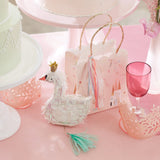 Meri Meri Princess Party Bag on a pink party table with a swan cake topper and a pink glass