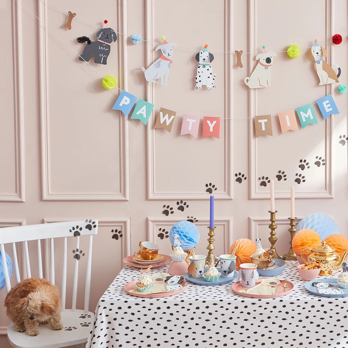 Puppy-themed party room with a Pawty Time banner and Meri Meri Puppy Cupcake Kit cupcakes