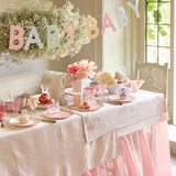 Meri Meri Scallop Edge Baby Garland hung over a baby shower table with flowers and cakes