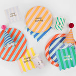 Meri Meri Stripe Happy Birthday Dinner Plates styled with striped napkins, party hats and cups