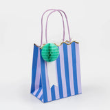 Meri Meri Stripe Party Bag in blue stripes with a mint honeycomb pom-pom and lilac handles