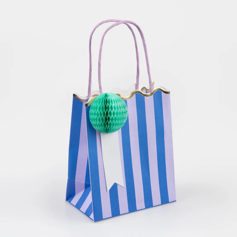 Meri Meri Stripe Party Bag in blue stripes with a mint honeycomb pom-pom and lilac handles