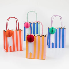 Meri Meri Stripe Party Bags in red, green, blue and orange stripes with honeycomb pom-poms and rope handles