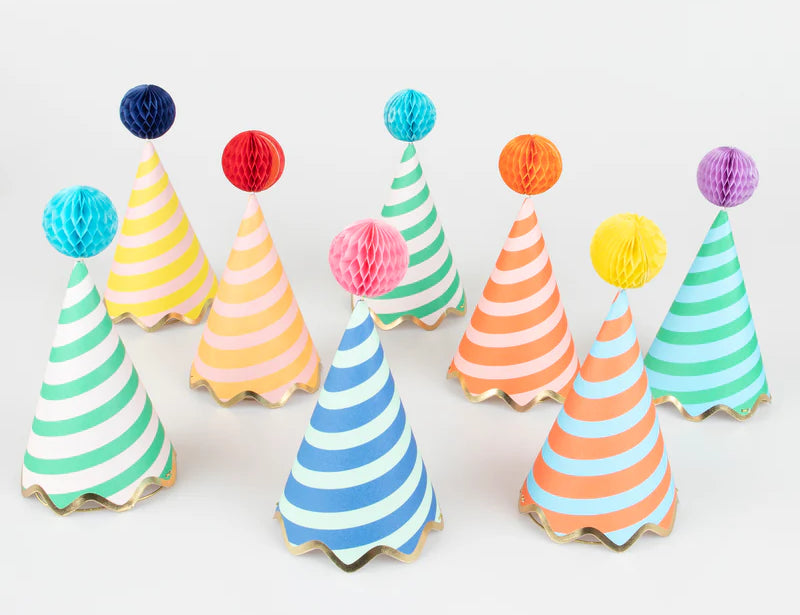Meri Meri Stripe Party Hats, a set of striped cone hats in assorted colors with honeycomb pom-pom tops