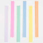 Meri Meri Super Skinny Mixed Candles in lilac, pink, mint, blue, yellow and orange laid in a row