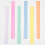Meri Meri Super Skinny Mixed Candles in lilac, pink, mint, blue, yellow and orange laid in a row
