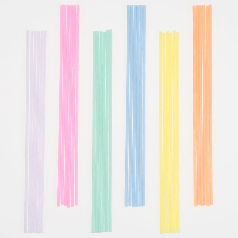 Meri Meri Super Skinny Mixed Candles in lilac, pink, mint, blue, yellow and orange laid in a row