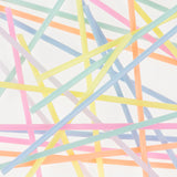 Meri Meri Super Skinny Mixed Candles scattered in a colorful crisscross pattern