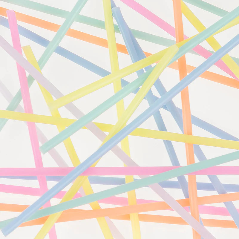 Meri Meri Super Skinny Mixed Candles scattered in a colorful crisscross pattern
