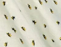 Milkbarn Bamboo Bumblebee Mini Lovey Blanket, close-up of the bumblebee print on sage muslin