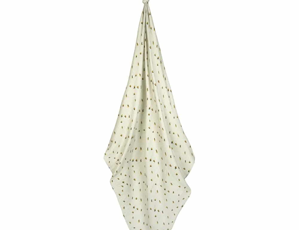Milkbarn Bamboo Bumblebee Swaddle Blanket, sage green muslin swaddle with bumblebee print hanging on white