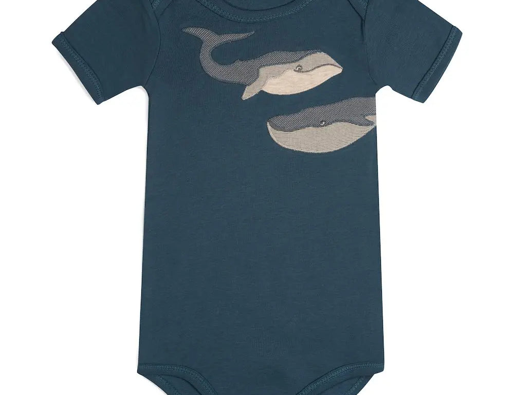 Milkbarn Blue Whale Short Sleeve One Piece, a navy blue baby bodysuit with a gray whale print