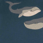 Close-up of the gray whale print on the navy Milkbarn Blue Whale Short Sleeve One Piece