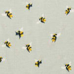 Close-up of the bumblebee print on the sage Milkbarn Bumblebee Short Sleeve One Piece