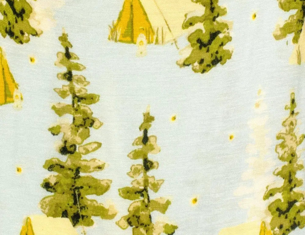 Close-up of the pine tree and yellow tent print on the Milkbarn Camping Two-Piece Burp Cloth Set