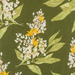 Close-up of the yellow and white floral print on the Milkbarn Green Floral Dress & Bloomer Set