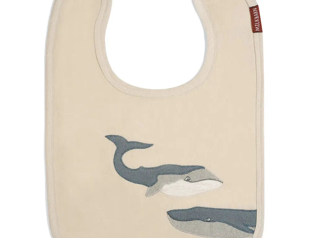 Milkbarn Whale Linen Two-Layered Bib, a cream linen bib with two appliqued gray whales
