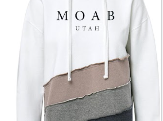 Two tone Moab colorblock hoodie in cream and taupe with a raw edge seam and Moab Utah lettering