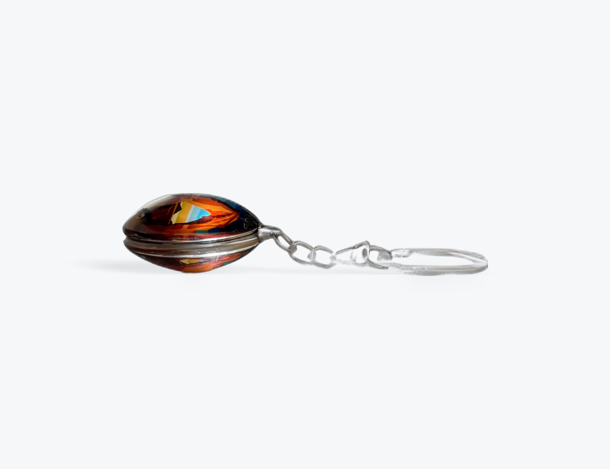 Round glass Moab keychain with Delicate Arch under a coral and peach sunset, second view