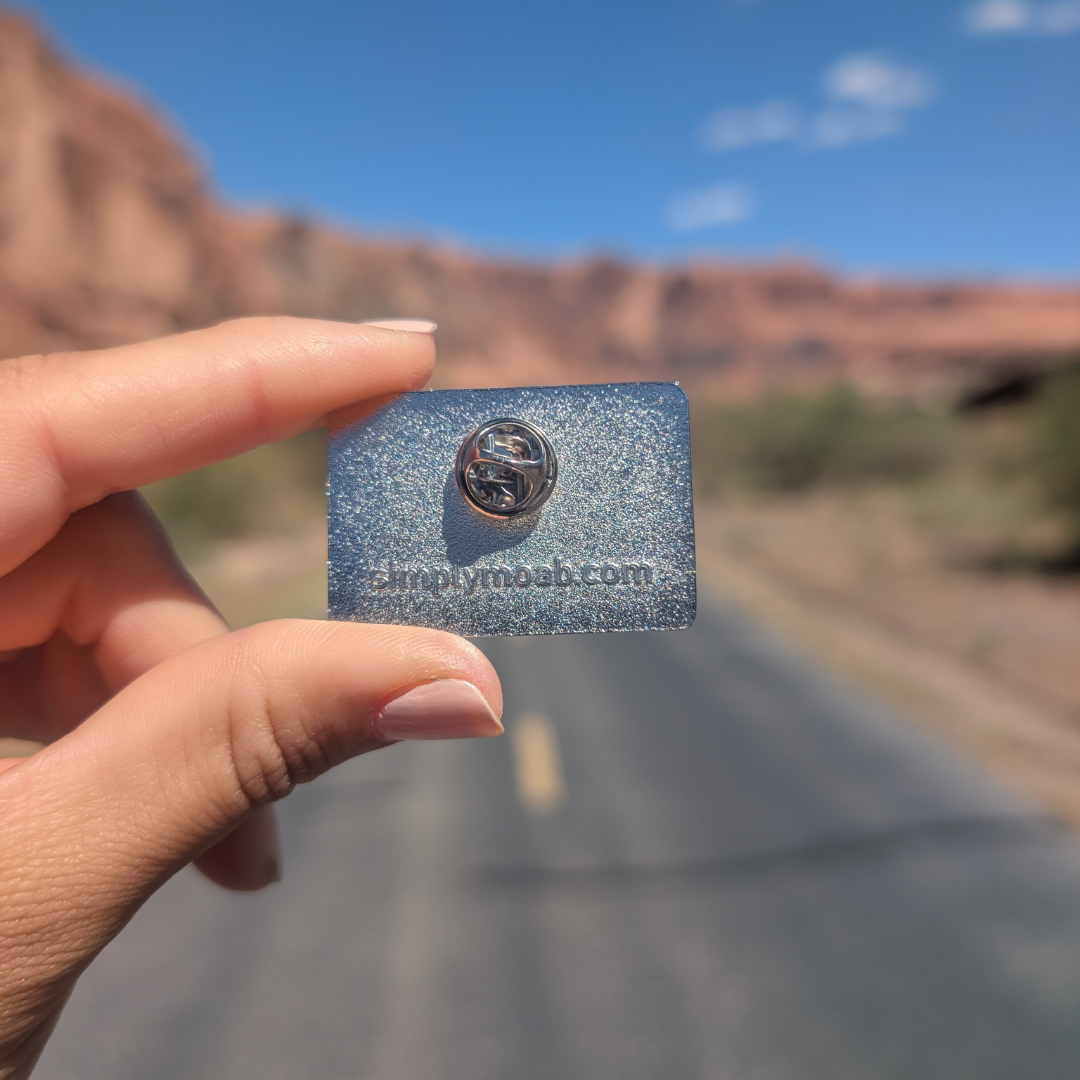 Back of the Moab Utah geometric sunset enamel pin showing the rubber clutch.