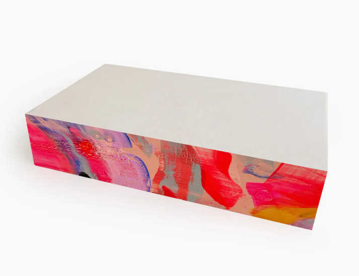 Moglea Candy Swirl Pad, a white notepad with hand-painted pink, red and blue swirled edges