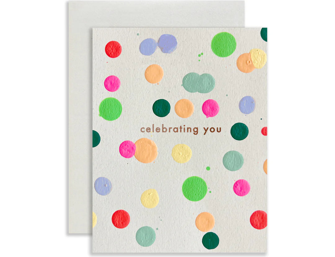 Moglea Celebrating Dot card, a white card with colorful painted dots reading celebrating you, with gray envelope