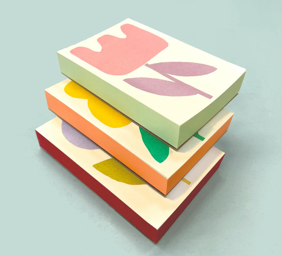 Three Moglea Flower Pads in Tulip, Oxalis and Dahlia stacked, showing their painted colored edges