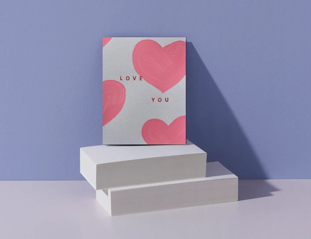 Moglea Heart Love You Card styled on white blocks against a lavender background