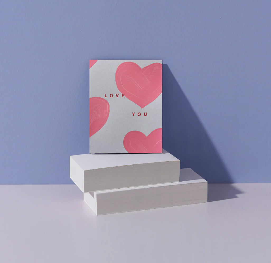Moglea Heart Love You Card styled on white blocks against a lavender background
