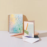 Moglea Painted Mystic Journal styled with painted cards on a peach backdrop
