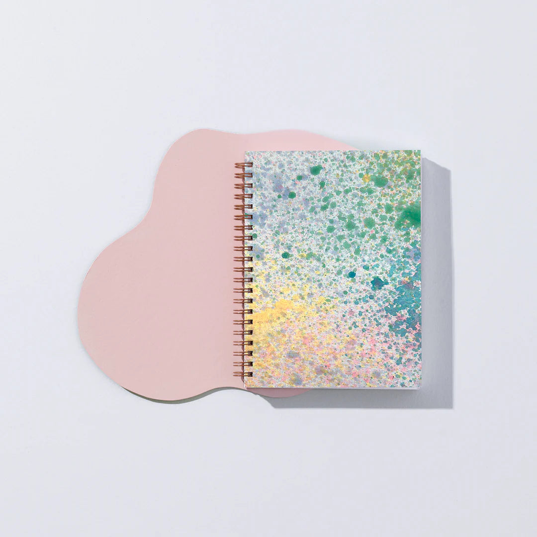 Moglea Painted Mystic Journal on a pink paper shape against a white background