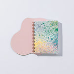 Moglea Painted Mystic Journal on a pink paper shape against a white background