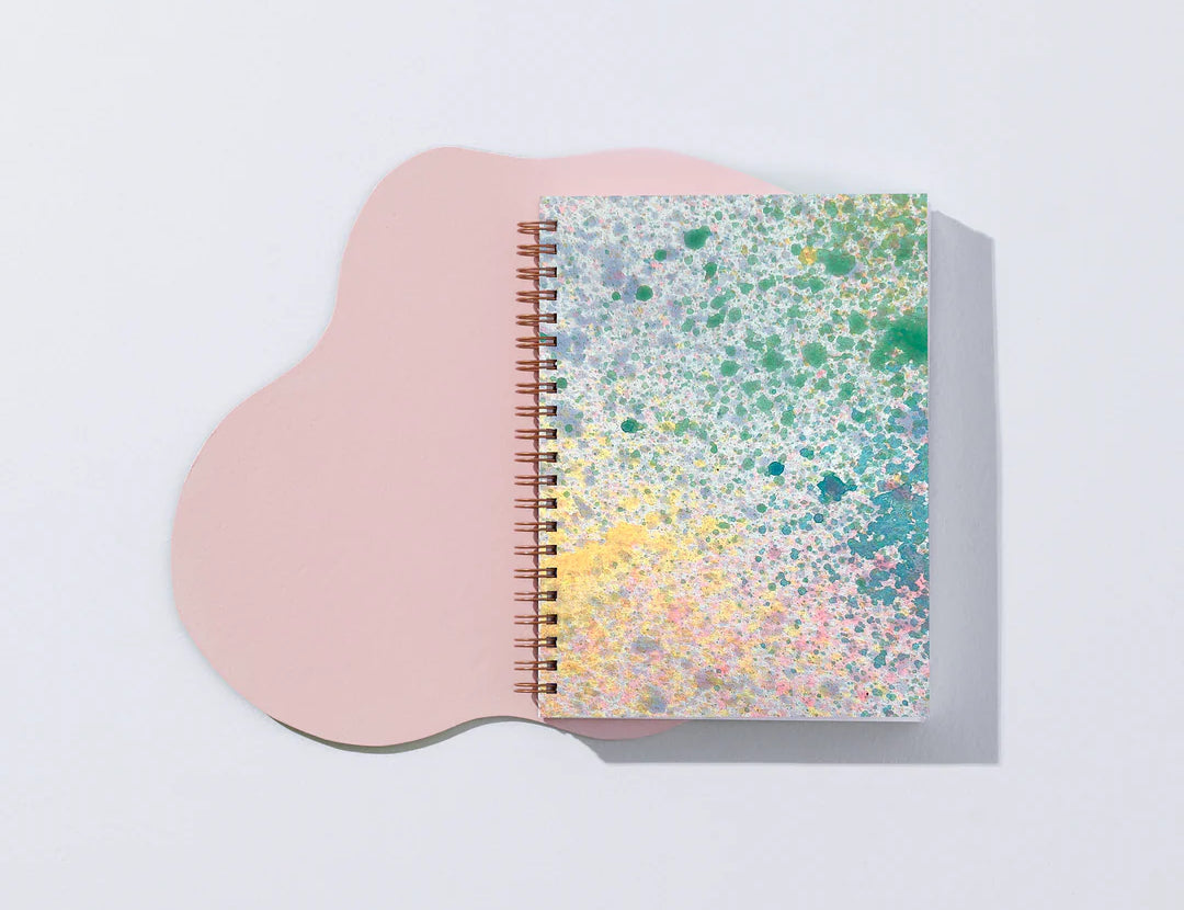 Moglea Painted Mystic Journal on a pink paper shape against a white background