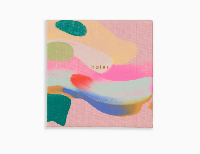 Moglea Palmita Togo Notes Pad, a pink notepad with a colorful painted abstract cover