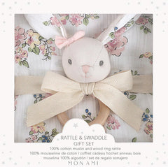 Mon Ami Muslin Swaddle & Rattle Gift Set in Parisian Floral, a bunny rattle on a floral swaddle in a gift box