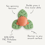 Mushie Dino Suction Spinner Toy with feature callouts: spinning function, motor skills, BPA free, suctions to smooth surfaces