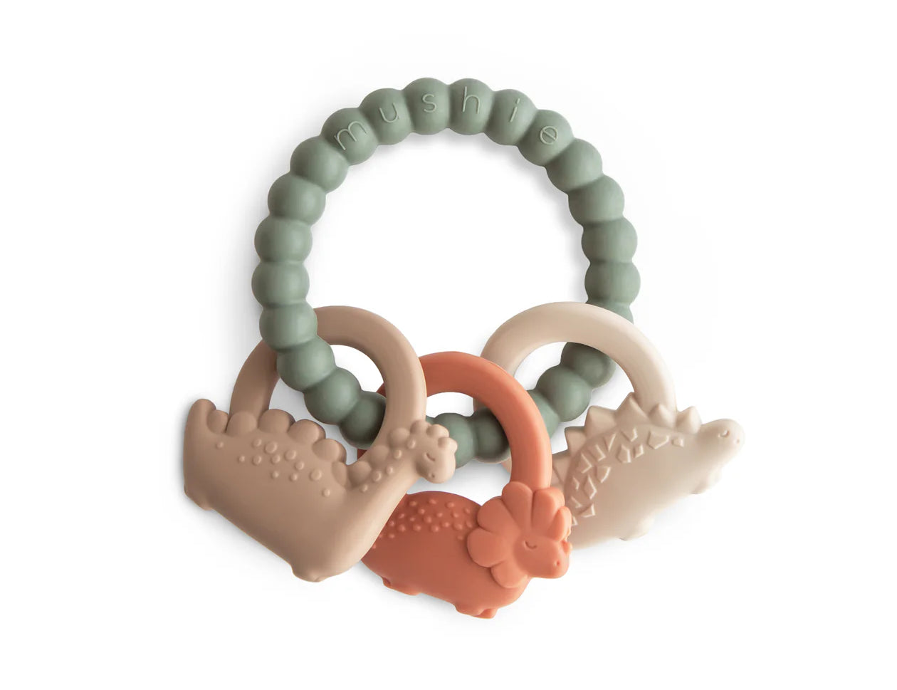 Mushie Dino Teething Ring, a sage green beaded silicone ring with tan and coral dinosaur charms