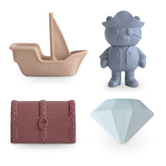 Mushie Mold Free Bath Play Set in Pirate, a tan ship, blue pirate bear, rust treasure chest and blue gem