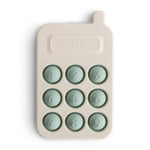 Mushie Phone Press Toy, a cream silicone toy phone with nine sage green pop-in number buttons