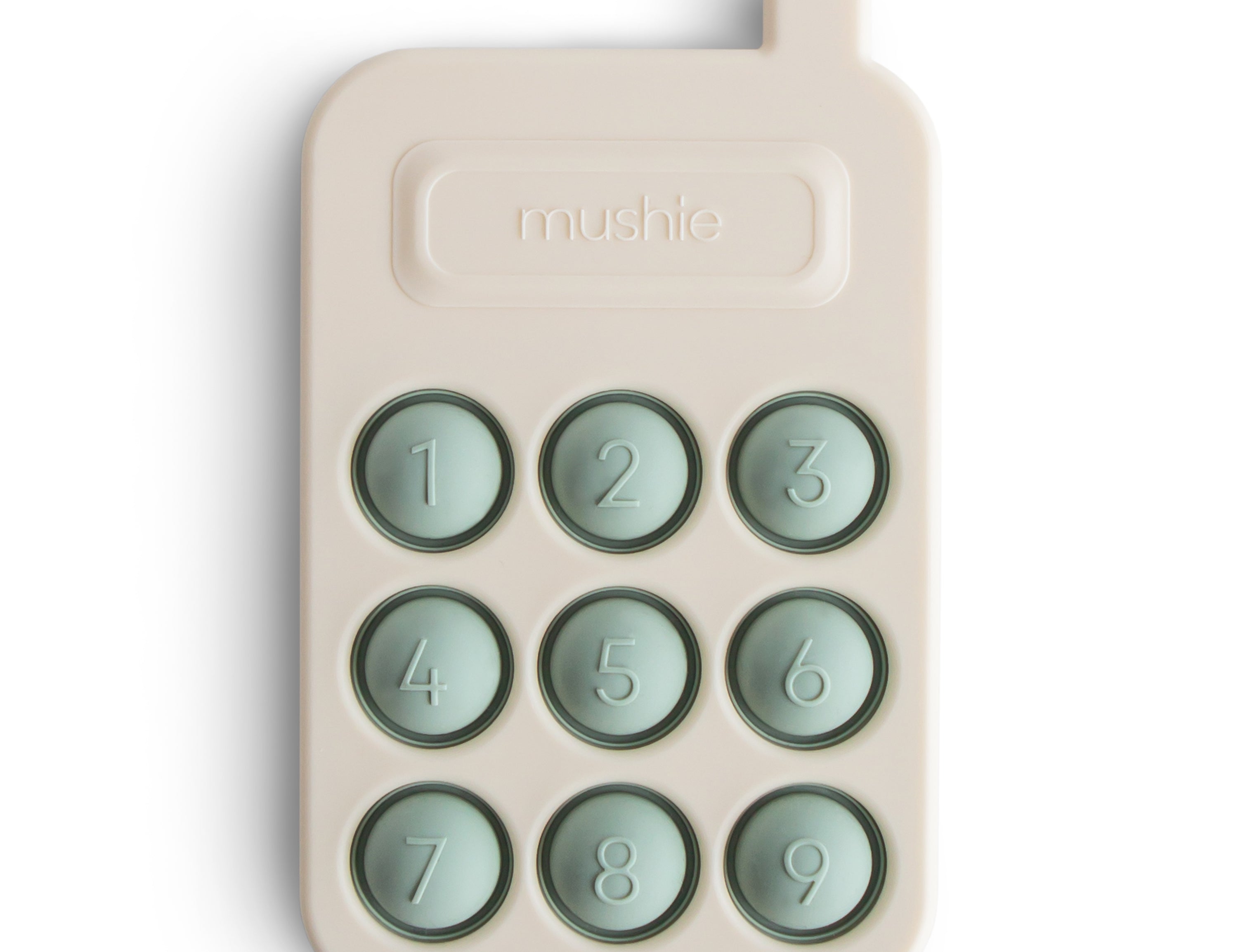 Mushie Phone Press Toy, a cream silicone toy phone with nine sage green pop-in number buttons