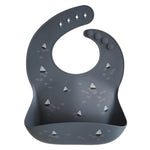 Mushie Silicone Baby Bib in Boat, a navy bib with a small sailboat print and a catch pocket