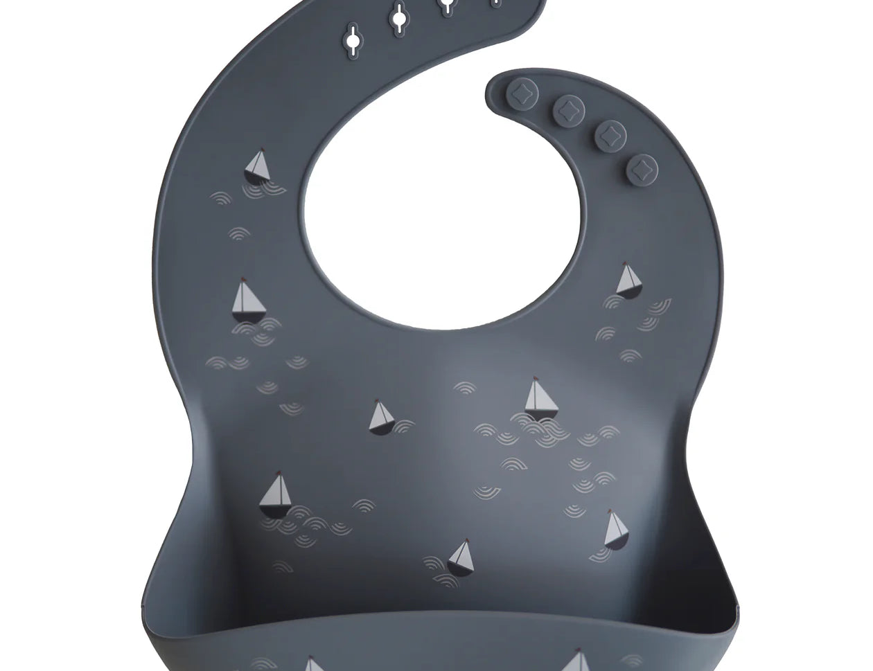 Mushie Silicone Baby Bib in Boat, a navy bib with a small sailboat print and a catch pocket