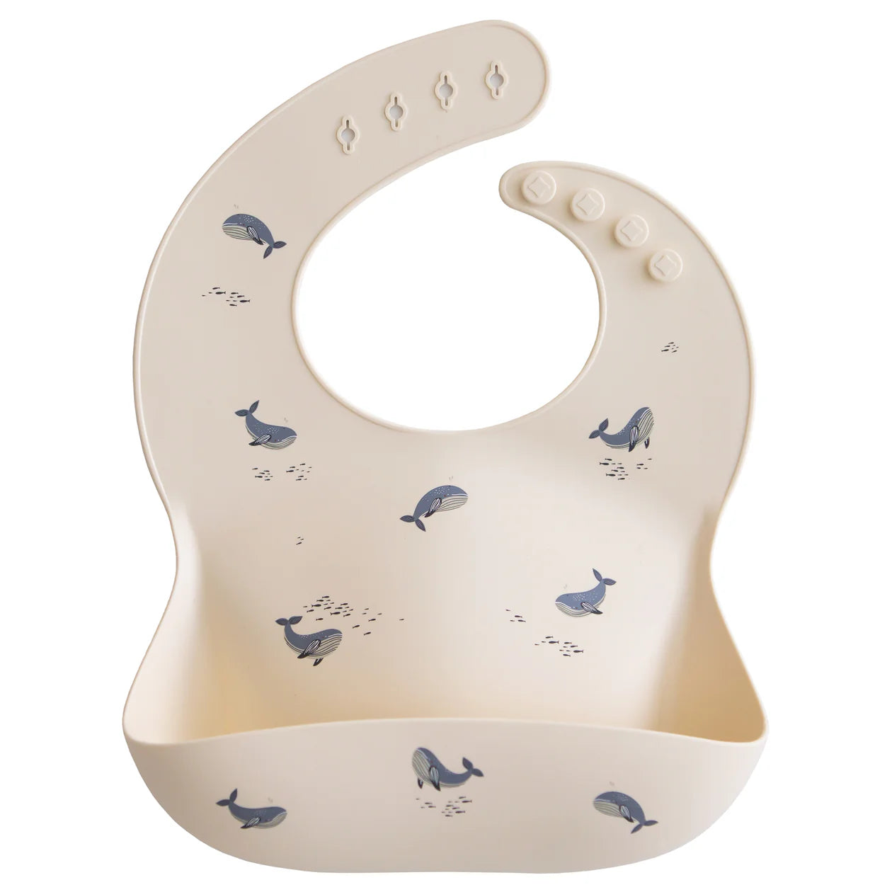 Mushie Silicone Baby Bib in Whales, a cream bib with a blue whale print and a catch pocket