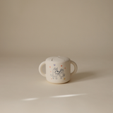 Mushie Snack Cup in Bluey Ivory on a neutral surface in soft light