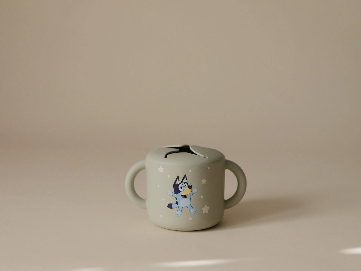 Mushie Snack Cup in Bluey Sage on a neutral surface in soft light