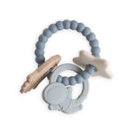Mushie Space Teething Ring, a blue beaded silicone ring with a planet, rocket and star charms